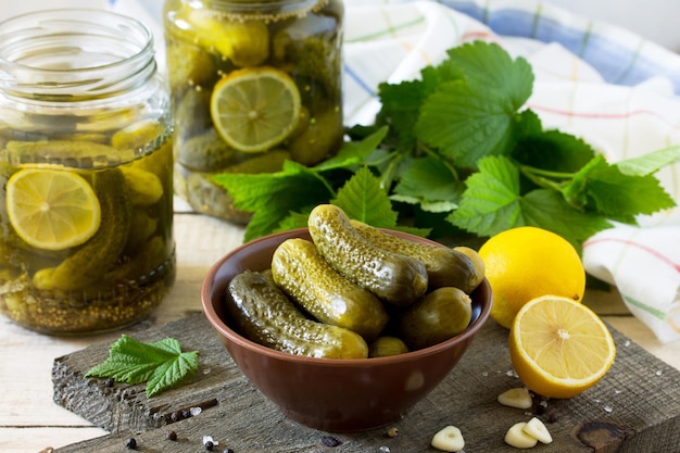 Marinated cucumbers gherkins Pickles marinated with lemon and garlic on the kitchen wooden table