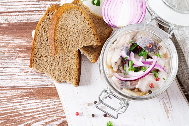 Marinated herring in jar with onions. Scandinavian food. 