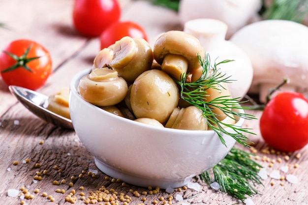 Marinated mushrooms vintage wooden background selective focus