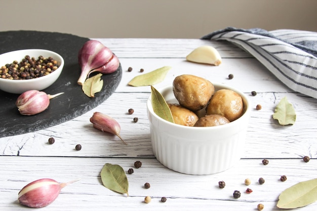 Marinated mushrooms with garlic black pepper and bay leaf Champignons marinated pickled mushrooms