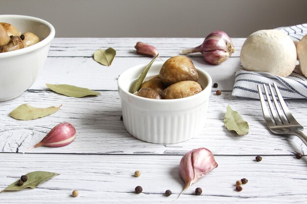 Marinated mushrooms with garlic black pepper and bay leaf Champignons marinated pickled mushrooms