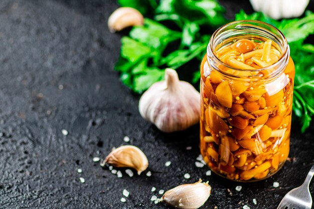 Marinated mushrooms with a glass jar with parsley and garlic