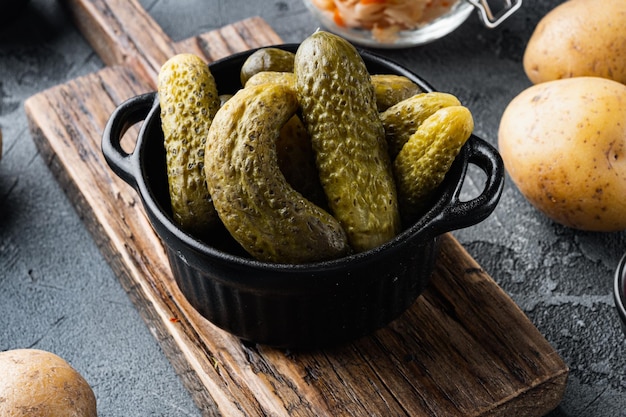 Marinated pickled cucumber on gray background