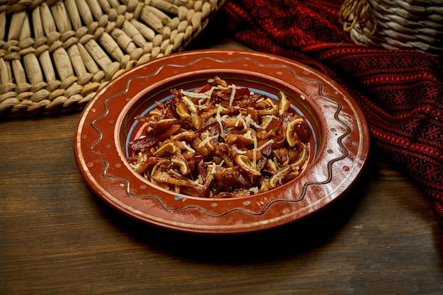 Marinated pig ears in a clay plate Ukrainian and Korean cuisine