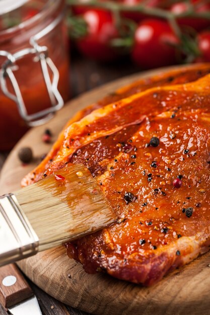 Marinated pork steak on cutting board and ingredients  for cooking