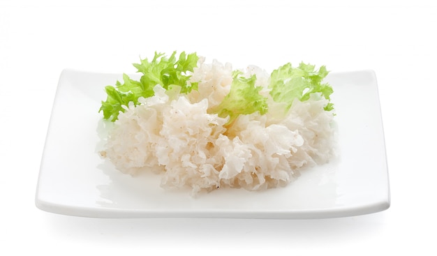 Marinated snow fungus with lettuce on the squared plate