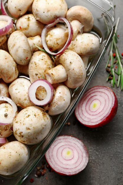 Marinating mushrooms with spices on table close up