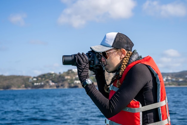 Marine biologist taking photos on the sea