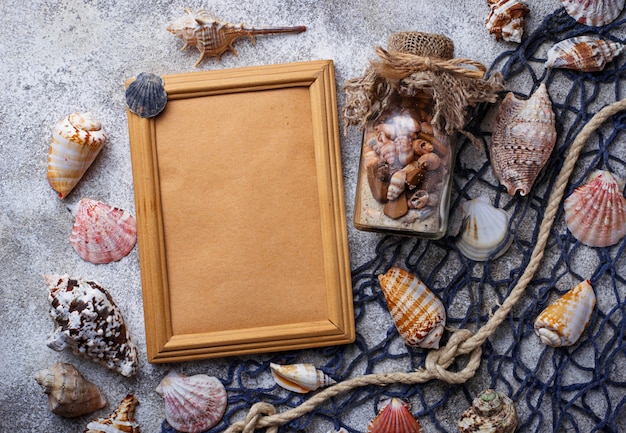 Marine items: sea shells, rope, fishnet. Nautical background. Space for text