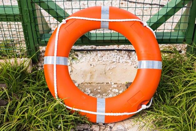 Marine lifebuoy on fence, safe for swim