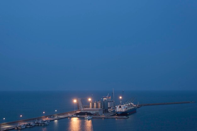 Marine port with boats at anchor at night