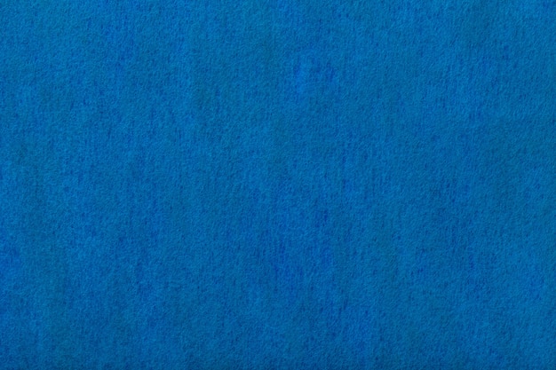 Marineblauwe matte suède stoffen achtergrond. fluwelen textuur van vilt.