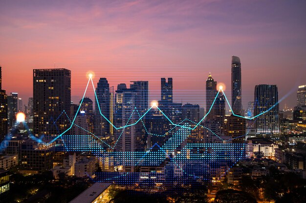 Market behavior graph hologram sunset panoramic city view of Bangkok popular location to achieve financial degree in Asia The concept of financial data analysis Double exposure