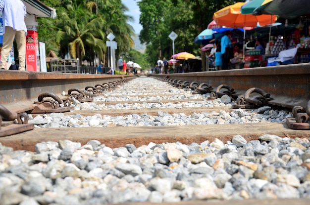 Market fair beside Railway train go to Bridge over the River Kwai on December 3 2015 in Kanchanaburi Thailand