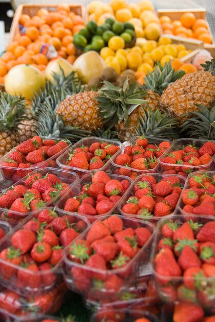 Market fruit stall with lots of strawberries and other fruits