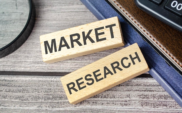 Market research words on wooden blocks and calculator