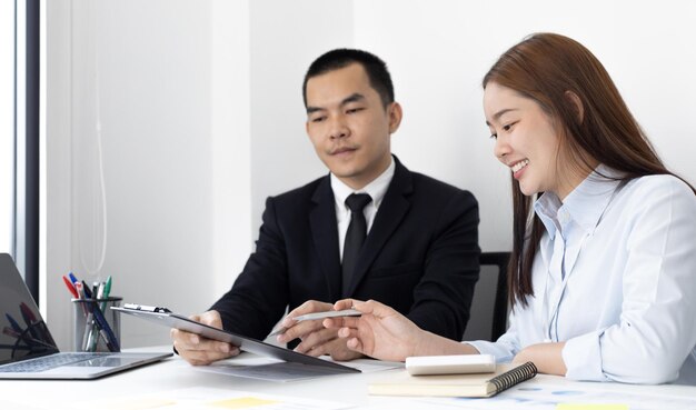 마케팅 전문가와 재무 회계사는 전략을 계획하기 위해 차트를 논의하고 분석하고 있습니다.