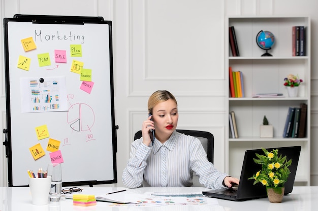 marketing smart cute business lady in striped shirt in office making a phone call