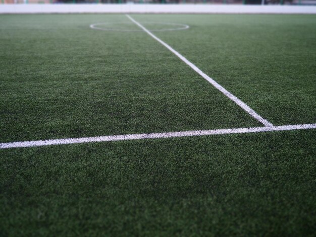 The marking of the football field on the green grass White lines no more than 12 cm or 5 inches wide Football field area