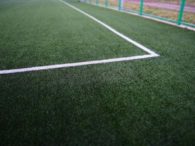 The marking of the football field on the green grass white
lines no more than 12 cm or 5 inches wide football field area