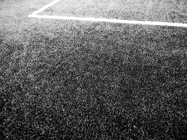 The marking of the football field white lines no more than 12\
cm or 5 inches wide football field area black and white monochrome\
photography