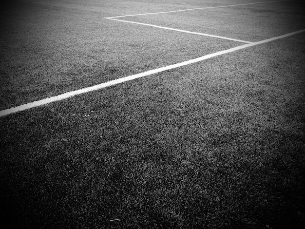The marking of the football field white lines no more than 12
cm or 5 inches wide football field area black and white monochrome
photography