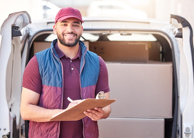 Marking off orders as I go. Cropped portrait of a handsome young male courier out making deliveries.