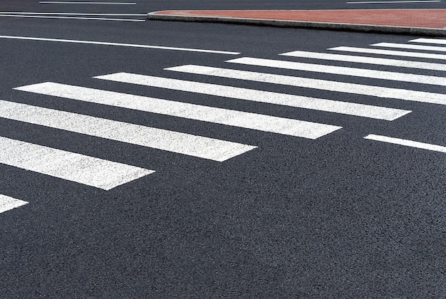 Markings of a pedestrian crossing on asphalt road Roads infrastructure and transport