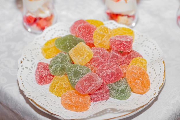 Marmalade colored jelly candies on a white plate