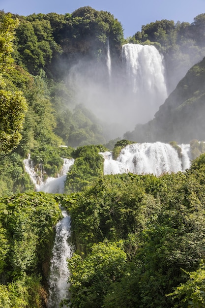 Marmore waterfall in Umbria region, Italy. Amazing cascade splashing into nature with trees and rocks.