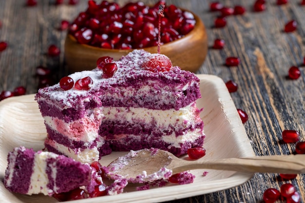 A marooncolored cake with the taste of different berries and a creamy milk filling of cottage cheese with pomegranate seeds