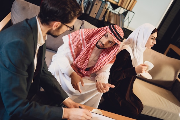 Married Arab couple at psychologist reception.