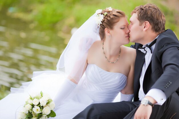 Married couple kissing in park