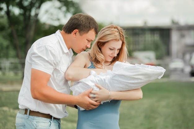 married couple looking at their newborn baby