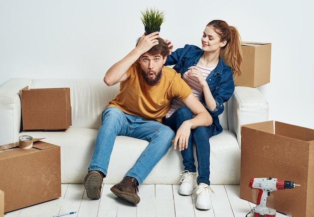 married couple moving boxes with things lifestyle emotions interior