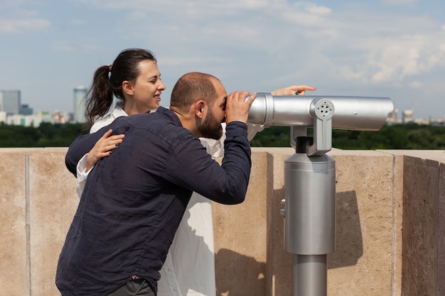 Married couple spending relationship anniversary on building rooftop