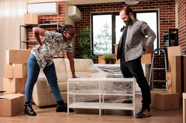 Premium Photo | Married life partners unpacking furniture to ...