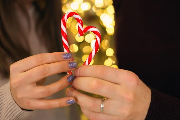 Married man with mistress holds lollipops in shape of heart