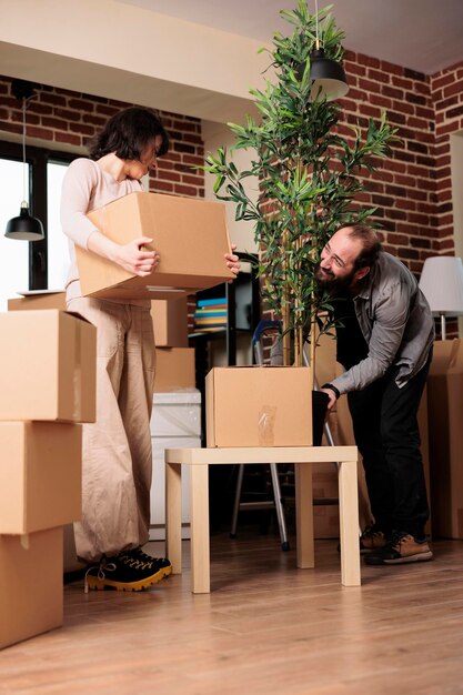 Married man and woman moving in new house bought together on mortgage loan, feeling positive about life event. Homeowners enjoying household relocation for new relationship beginnings.