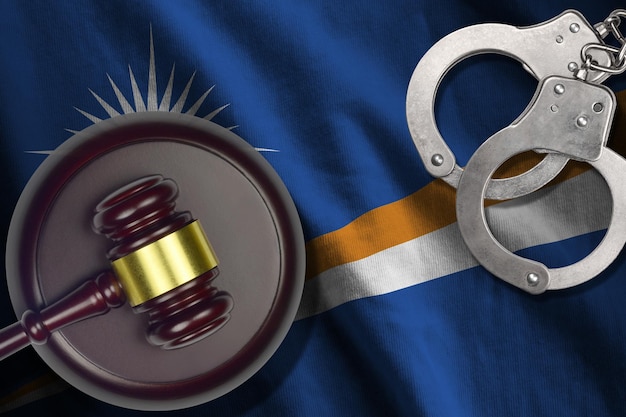 Photo marshall islands flag with judge mallet and handcuffs in dark room concept of criminal and punishment background for judgement topics