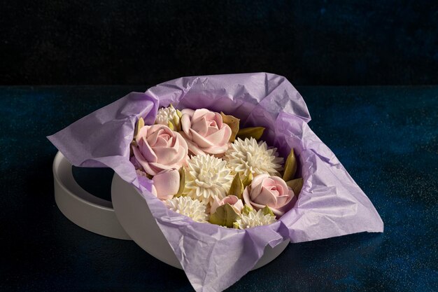 Marshmallow bouquet of flowers in a gift box on a blue
background festive mood valentine's day international women's
day