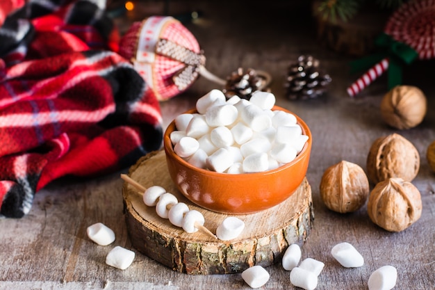 Marshmallow in a bowl on a wooden table