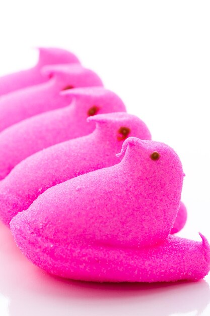 Marshmallow chicks for Easter on a white background.