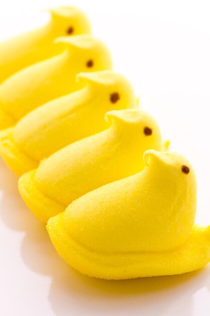 Marshmallow chicks for Easter on a white background.