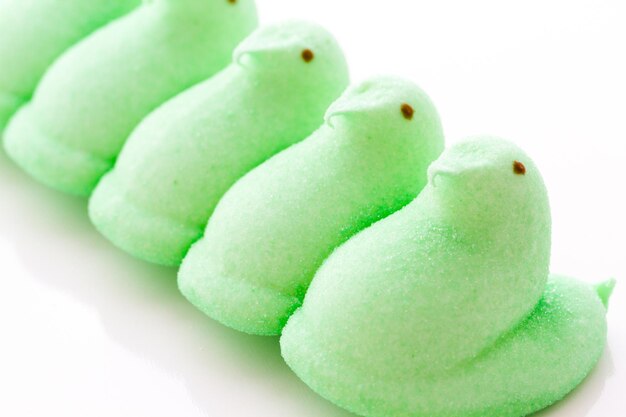 Marshmallow chicks for Easter on a white background.