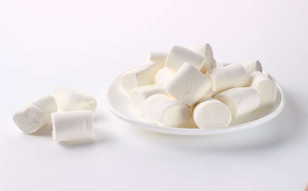 Marshmallow in a plate on a white surface