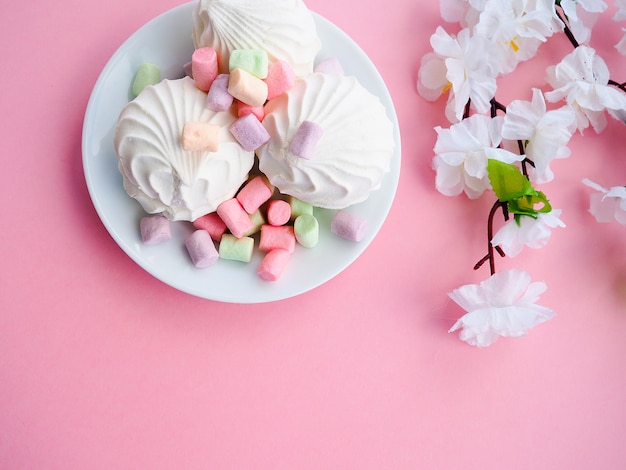 Marshmallow in white plate on pink