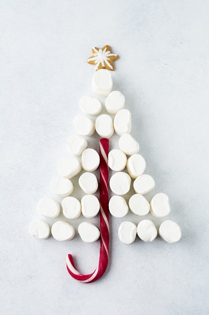 Marshmallows and Christmas lollipop on gray background