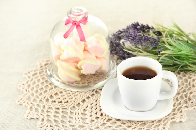 Marshmallows on saucer with transparent cover on light background