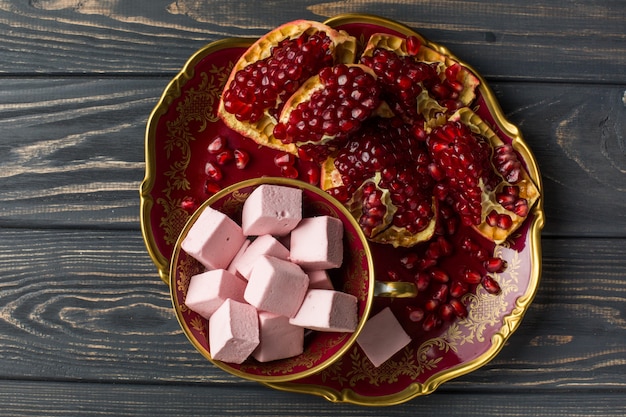 Marshmelow and pomegranate on the table